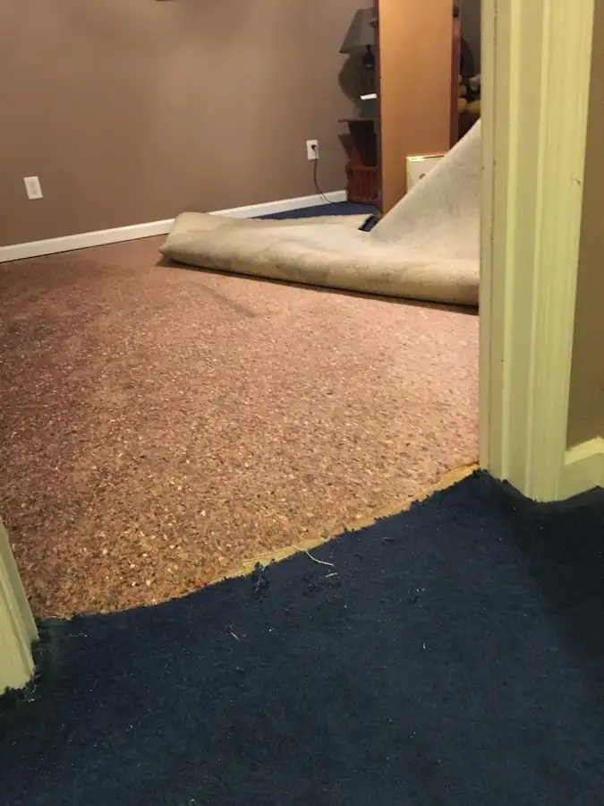 Carpet pad removal revealing water damage during Water Mitigation Services in Imperial