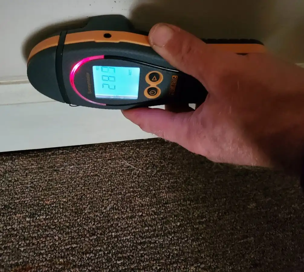 Moisture detection at baseboard during Storm Damage Restoration in Imperial